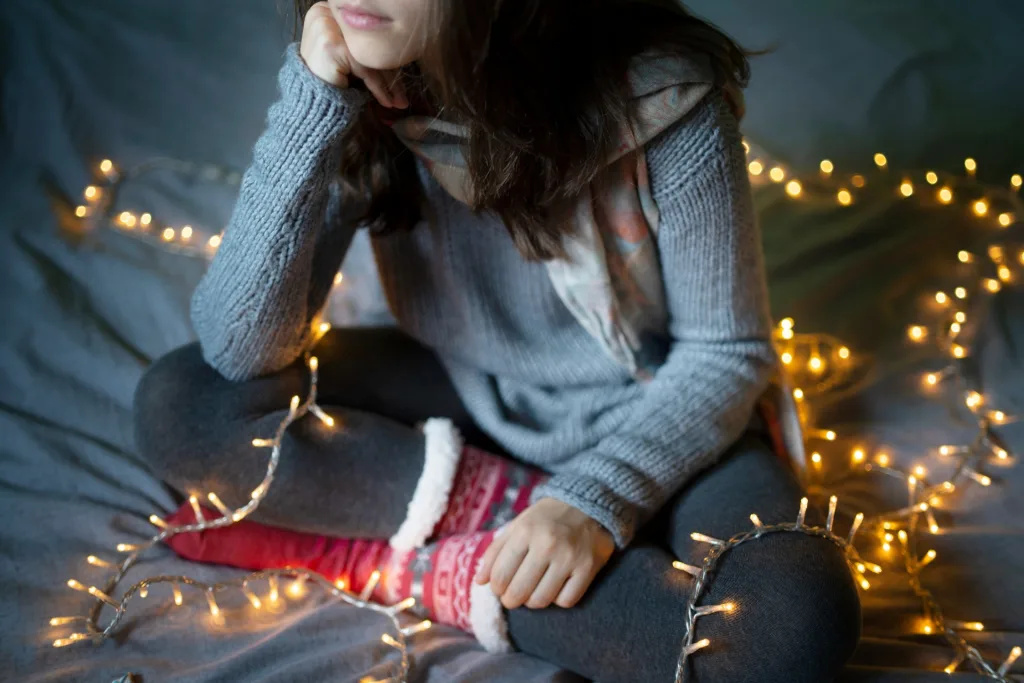 woman-resting-her-head-while-sitting-on-a-bed